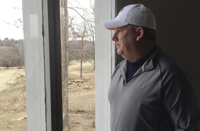 In this March 9 photo, Marshall County resident Jeff Dysinger looks out a window in Benton, Ky. Dysinger's daughter, Hannah, was injured by gunfire in the shooting at Marshall County High School on Jan. 23, but Dysinger, who owns an AR-15 rifle, is opposed to further gun reforms. [AP Photo/Dylan Lovan]