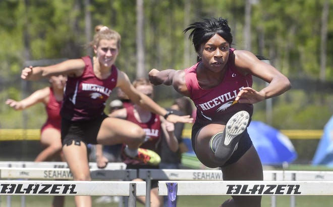 Niceville's Tykeyra Beacham clears a hurdle during Thursday's FHSAA 3A District 2 meet at the Emerald Coast Middle School. Beacham took first in the 100 meter and 300 meter hurdle events.

[DEVON RAVINE/DAILY NEWS]