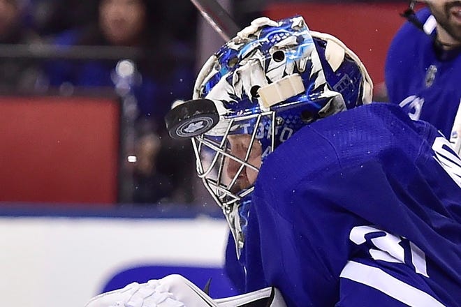 Toronto Maple Leafs goaltender Frederik Andersen makes a save off his helmet during the third period in the first round of the NHL playoffs against the Boston Bruins on Monday. The Leafs won to force Game 7 on Wednesday. [FRANK GUNN/THE CANADIAN PRESS via AP]