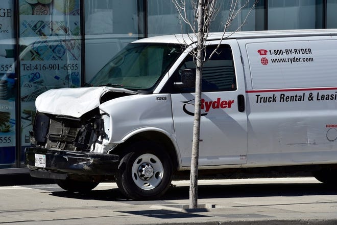 A van with a damaged front-end sits idle on a sidewalk after the driver drove down a sidewalk crashing into a number of pedestrians in Toronto, Monday, April 23, 2018. The van apparently jumped a curb Monday in a busy intersection in Toronto and struck the pedestrians and fled the scene before it was found and the driver was taken into custody, Canadian police said.