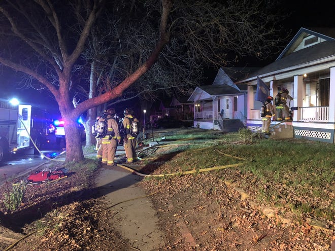 Topeka firefighters worked to quickly put out a small house fire Tuesday night at 120 S.W. Kendall Ave. [Katie Moore/The Capital-Journal]