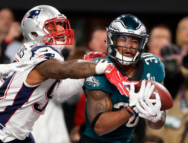 Philadelphia's Corey Clement catches a touchdown pass in front of New England's Marquis Flowers in the second half of Super Bowl 52. While first-round picks receive most of the attention and players chosen the first two days of the draft get more money and better job security, success on Day 3 of the draft often separates the elite teams from the good ones. That was evident when the Eagles and Patriots met in February. [Jeff Roberson/The Associated Press]