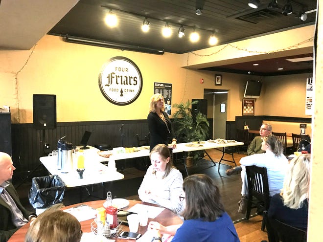 Lisa Coe of Fivestar Realty talks about Homes for Heroes with those gathered for the Ionia Area Chamber of Commerce Connect Breakfast Connect event at Four Friars on Tuesday. [DICK HOEKSTRA/SENTINEL-STANDARD}
