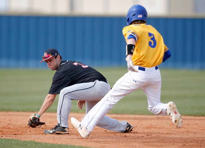 Carl Albert's Carter LaValley tags out Piedmont's Trace Larson during a 6-3 win Tuesday in Piedmont. [Photo by Sarah Phipps, The Oklahoman]