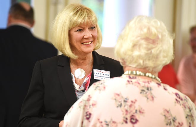 Columbia County Commission chairperson candidate Pam Tucker talks with voters during the political forum Thursday in Grovetown. [MICHAEL HOLAHAN/THE AUGUSTA CHRONICLE]