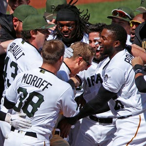 Pittsburgh Pirates' Corey Dickerson, center, celebrates with teammates after hitting a walk-off solo home run off Tigers relief pitcher Alex Wilson in the bottom of the ninth inning of a baseball game in Pittsburgh, Thursday, April 26, 2018. The Pirates won 1-0.(AP Photo/Gene J. Puskar)