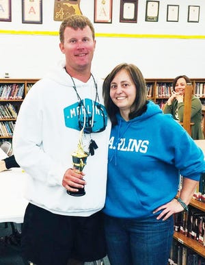 Amy Giraldo passed on the Magnificent Marlin award to Coach Matthew Cawthon for the month of April. The Magnificent Marlin award goes to a staff member who displays extraordinary passion for DMS and our students. [CONTRIBUTED PHOTO]