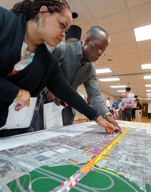 Tara Watson Friday and Lexington City Councilman Donald Holt study one of the maps for the proposed widening of Winston Road in Lexington during a North Carolina Department of Transportation public meeting at the Edward C. Smith Civic Center on Thursday. [Donnie Roberts/The Dispatch]