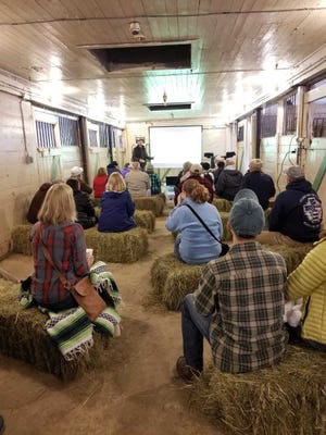 Participants watch a complimentary slideshow at the Apple Tree Grafting Workshop. [Courtesy photo]