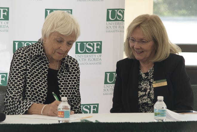 Karen Holbrook, left, regional chancellor of the University of South Florida Sarasota-Manatee, and Melanie Michael, vice dean of academic programs at USF Health College of Nursing, sign the paperwork Thursday to launch a new nursing bachelor-degree program at the USFSM campus. [PHOTO COURTESY OF USFSM]
