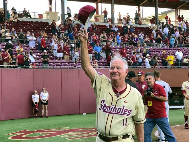 Florida State coach Mike Martin salutes the crowd at Dick Howser Stadium in Tallahassee on Feb. 19, 2017, after he got his 1,900th win. [AP Photo / Joseph Reedy, File]
