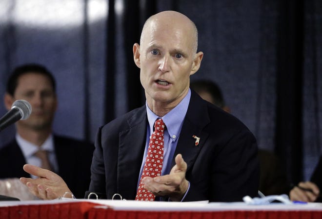 >

              Gov. Rick Scott gestures during a meeting of the Florida Cabinet, whose members also serve as the state's Clemency Board. [ AP FILE PHOTO ]