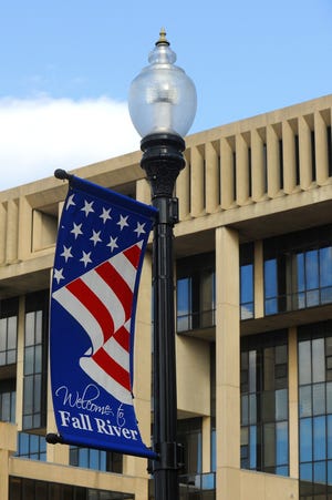 A street banner is seen downtown with a Government Center backdrop. A new program would replace these types of banners with those displaying the "Make it Here" logo and business sponsorships. [Herald News Photo | Jack Foley]