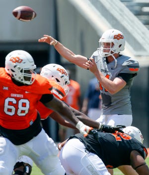 Taylor Cornelius, right, took the first step toward possibly replacing Mason Rudolph as Oklahoma State's starting quarterback. Cornelius played well Saturday during the Cowboys' spring football game. [PHOTO BY NATE BILLINGS, THE OKLAHOMAN]