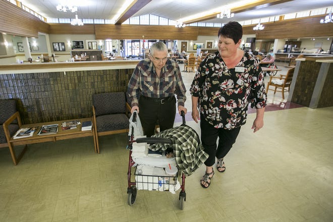 Jerry DeWitt, a resident at River Bluff Nursing Home, and Sheila Story, River Bluff administrator, walk into one of the activity rooms on Tuesday, April 24, 2018. [ARTURO FERNANDEZ/RRSTAR.COM STAFF]