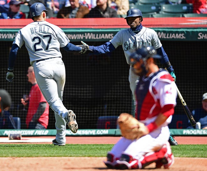 Seattle Mariners' Ryon Healy, left, is congratulated by Dee Gordon after Healy hit a solo home run in the sixth inning of a baseball game against the Cleveland Indians, Sunday, April 29, 2018, in Cleveland. (AP Photo/David Dermer)