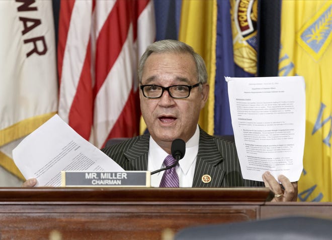 In this July 24, 2014 file photo, House Veterans Affairs Committee Chairman Jeff Miller, R-Fla., holds up two pages of resource requests from the Department of Veterans Affairs during a hearing on Capitol Hill in Washington. [ AP FILE PHOTO ]