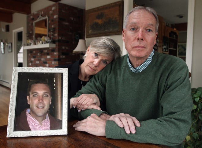 David and Linda Whelan with a photo of their son David Whelan, who they affectionately called "Davey Boy". David was a former Westerly basketball player who died of an opiate overdose. [The Providence Journal / Bob Breidenbach]