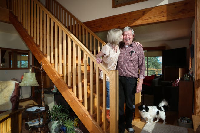 Susan and Paul Randall on their stairs that were partly made from the old fir recycled from a building downtown. (Kelly Lyon/The Register-Guard)