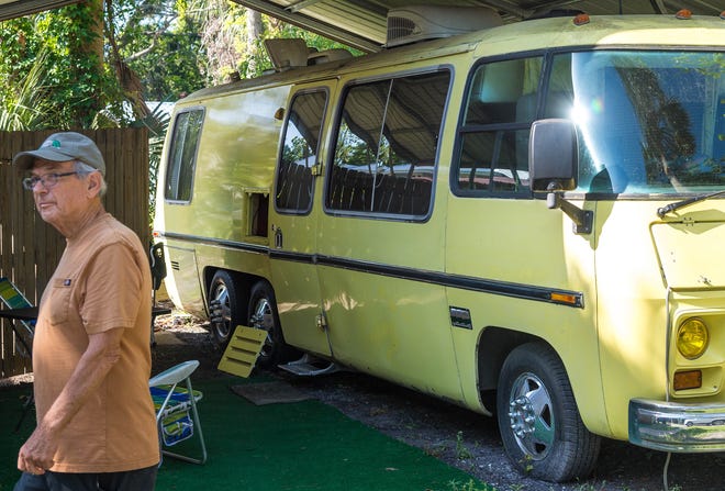 Tom Gibes walks from a motorhome he calls the Yellow Submarine on his property in St. Augustine on Friday. Gibes rents the motorhome through the website Airbnb and uses the money to supplement his retirement income. [PETER WILLOTT/THE RECORD]