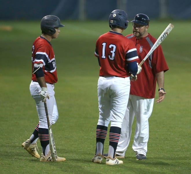 Bozeman baseball coach Jeff Patton stresses a point to Chad McCann (13) in a game earlier this month. [PATTI BLAKE/THE NEWS HERALD]