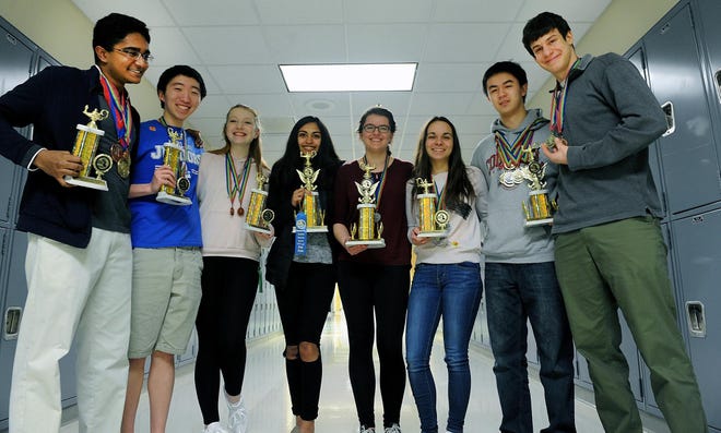The Ashland High School Academic Decathalon Team, posing a month before the Texan competition with past trophies and medals. From left: Neeraj Padmanabhan; James Lee; Hannah Wood; Poorva Bagchee; Brianna Doucette; Paulina Chunakou; Arthur Wang; Alon Efroni. [Daily News File Staff photo/Art Illman]