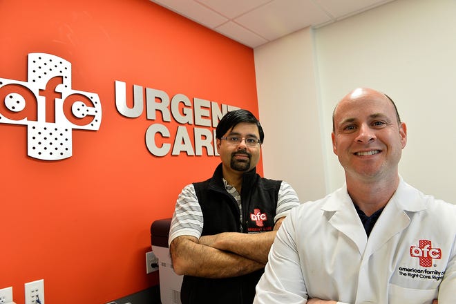 Physician Assistant Adam Rodman, right, stands with Urgent Care owner/manager Zaka Shafiq at the new AFC Urgent Care facility in Swampscott. [Wicked Local Photo / Joseph Prezioso]