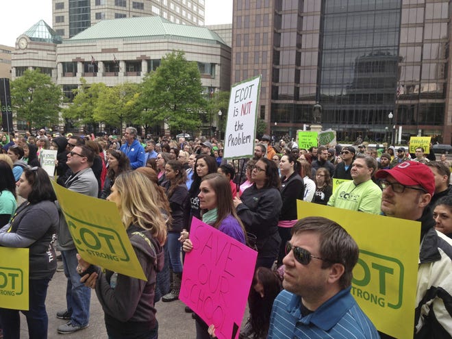 FILE In this May 9, 2017, file photo, hundreds of supporters of Ohio's largest online charter school, the Electronic Classroom of Tomorrow or ECOT, participate in a rally outside the Statehouse in Columbus, Ohio. Education regulators are reviewing a whistleblower's claim that the online charter school, which abruptly closed in Jan. 2018, inflated attendance figures tied to its state funding, The Associated Press has learned, using software purchased after previous allegations of attendance inflation. (AP Photo/Julie Carr Smyth, File)