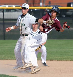Zeeland West's Clayton Kuipers tags out Holland Christian's Matthew Spaulding near second base in a doubleheader on Tuesday. [Chris Zadorozny/Sentinel staff]