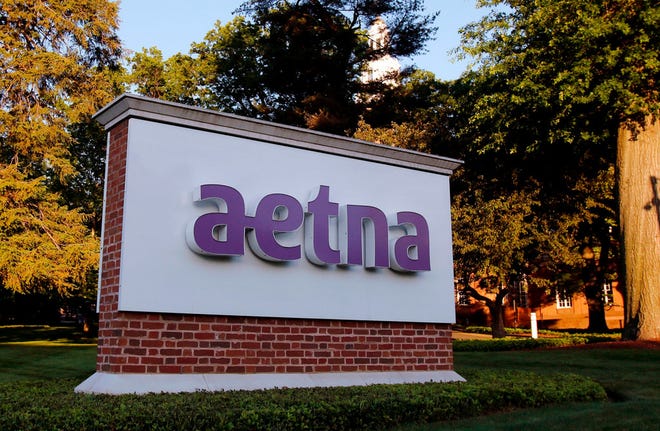 In this June 1, 2017, file photo, a sign stands on the campus of the Aetna headquarters in Hartford, Conn. Some major health insurers plan to take a little sting out of prescription drug prices by giving customers rebates at the pharmacy counter, and they could spark a trend. Aetna and UnitedHealthcare both say they will begin passing rebates they get from drugmakers along to some of their customers starting next year. (AP Photo/Bill Sikes, File)