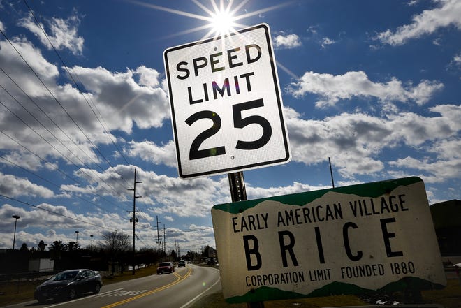 A speed limit sign welcomes drivers to the small Village of Brice east of Columbus as cars head north on Brice Road, Friday afternoon, February 21, 2014. To pay for the Brice Police force officers lie in wait along Brice road for motorist to drive over 25 miles per hour. (The Columbus Dispatch / Eamon Queeney)