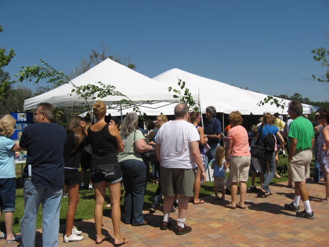 Residents lined up early for their free tree at a previous Arbor Day celebration in Central Park at Town Center in Palm Coast.This year's celebration takes place May 5 and once again resident will have the opportunity to take home a free tree in exchange for a non-perishable food item. [News-Tribune file]