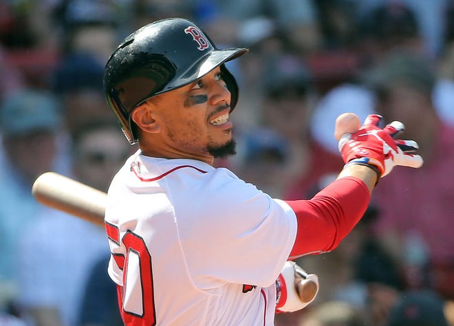Mookie Betts follows through on his third homer run against the Royals on Wednesday.