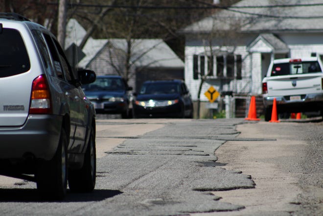 A small, partially-grooved stretch of Highland Street between Florence Street and Smith Avenue was closed to non-residents on Wednesday, as road crews filled potholes and conducted patchwork. Mayor Thomas Hoye said that both Highland and Anderson Street should be paved and completed by the end of the week. (Taunton Gazette photo by Jordan Deschenes)