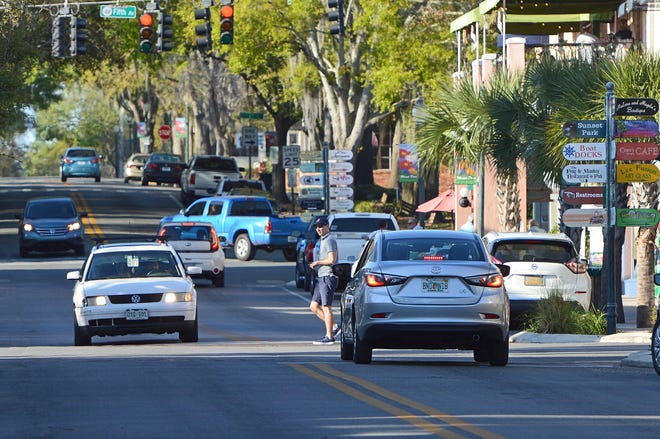 A pedestrian crosses Donnelly Street in downtown Mount Dora on March 5, 2018. [Whitney Lehnecker/Daily Commercial]