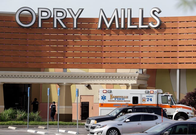 An ambulance sits outside Opry Mills mall Thursday, May 3, 2018, in Nashville, Tenn. Nashville police said a suspect was taken into custody after a person was shot and killed inside the mall. The mall was evacuated after the gunfire was reported. (AP Photo/Mark Humphrey)