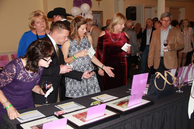 People browse items for auction at the 2017 Faces of Hope benefit for Cancer Services of Gaston County. This year's event takes place Friday, May 4. [PHOTO COURTESY OF CANCER SERVICES OF GASTON COUNTY]