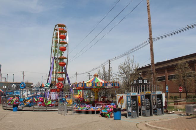 The Tulip Time carnival begins being set up in the Civic Center parking lot in downtown Holland on May 2, 2018. [Sydney Smith/Sentinel Photo]