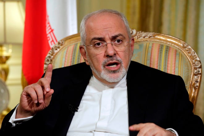 FILE - In this April 24, 2018, file photo, Iran's Foreign Minister Mohammad Javad Zarif is interviewed by The Associated Press, in New York. Zarif has taken to YouTube on Thursday, May 3, to criticize President Donald Trump's threat to withdraw from the nuclear deal, saying Iran will not "renegotiate or add onto" the atomic accord. (AP Photo/Richard Drew, File)
