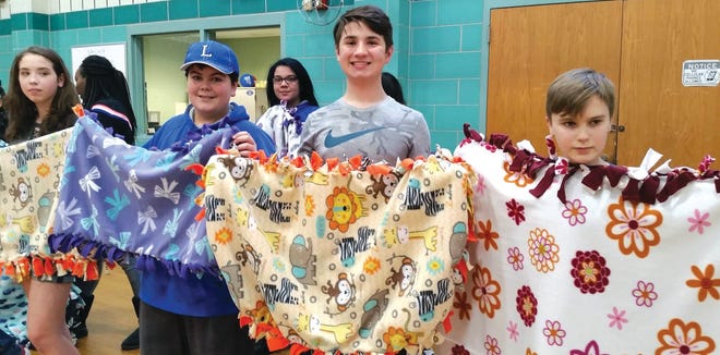 Samoset Middle School students show the no-sew blankets they made Friday, April 13 and presented to several local agencies. SUBMITTED PHOTO