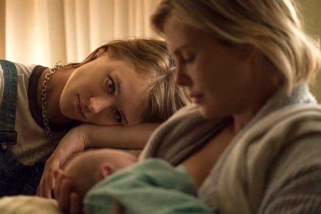 This image shows Mackenzie Davis , left, and Charlize Theron in a scene from "Tully." [Focus Features]