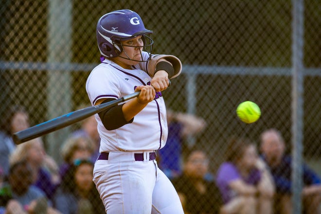 Gainesville's Hallie Karas swings at the ball during the girls softball regional quarterfinal game against Nease Wednesday night. The host Hurricanes won 5-0.