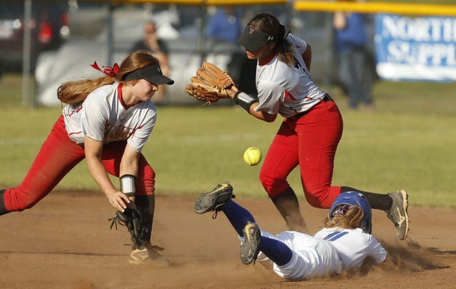 Tuscaloosa County runner Riley McWaters slides safely into second with a stolen base as the Wildcats hosted Thompson in the Class 7A, Area 5 tournament on Thursday. The throw to second gets away from Lauren Haskins and Allie Miller. [Gary Cosby Jr./Staff Photo]