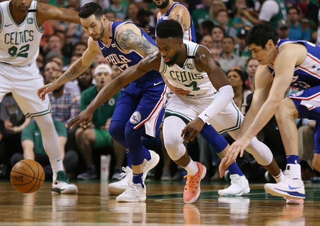 Boston Celtics guard Jaylen Brown (7) chases a loose ball against Philadelphia 76ers guard JJ Redick (17) and forward Ersan Ilyasova, right, during the first quarter of Game 2 of an NBA basketball second-round playoff series Thursday, May 3, 2018, in Boston. (AP Photo/Elise Amendola)