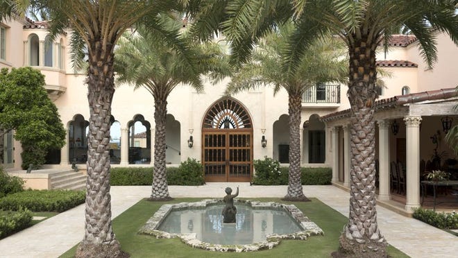 Leading from the courtyard into the original part of the house, a pair of doors topped by a Gothic arch with spindle details mimics the design of the front doors on the opposite facade at 280 N. Ocean Blvd. Photo by Stephen Leek, courtesy Preservation Foundation of Palm Beach