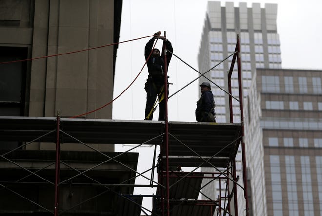 FILE- In this Feb. 20, 2018, file photo, construction workers work in midtown Manhattan in New York.  U.S. productivity grew at an annual rate of 0.7 percent in the first three months of 2018, a weak reading but a slight improvement from the previous quarter.(AP Photo/Seth Wenig, File)
