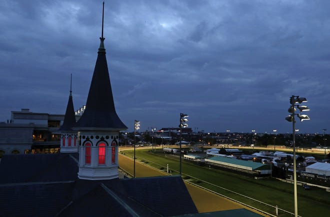 Horses train on the track before the 144th running of the Kentucky Oaks horse race at Churchill Downs on Friday. The 144th Kentucky Derby is Saturday. [AP Photo/Darron Cummins]