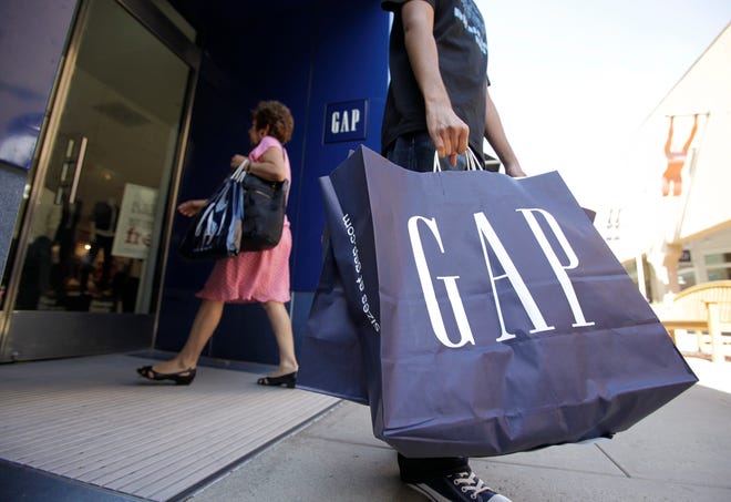 A shopper leaves a Gap clothing store in California. [Paul Sakuma/The Associated Press/File]