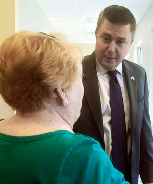 Republican gubernatorial candidate Scott Dawson talks with Judy Lambert at a senior citizen center in Jasper, Ala., on Wednesday, May 2, 2018. Dawson, a first-time candidate, is seeking the GOP nomination for governor with an appeal that stresses his background as a Christian evangelist, not a politician. (AP Photo/Kim Chandler)