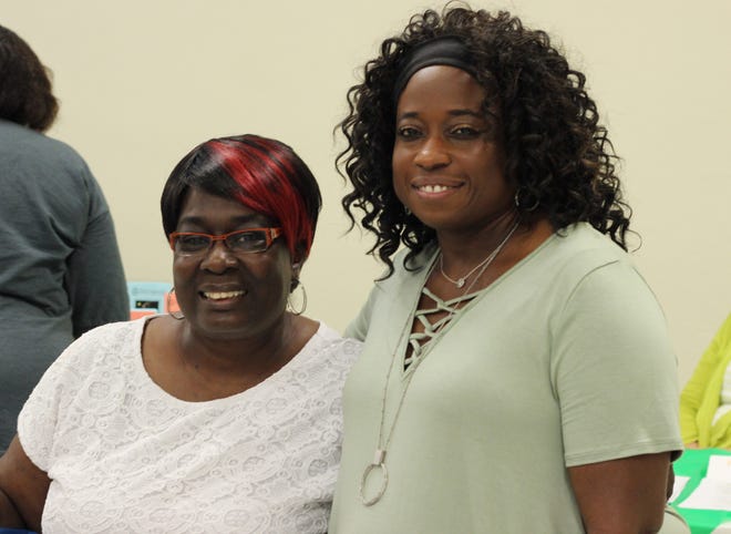 Jennette Martin, left, and Crystal Knight, right, are old friends and former coworkers who reunited at the housing fair. Both are renters who hope to buy a home, and they came to the fair to gain knowledge about how to start the home buying process. [Jewell Tomazin]